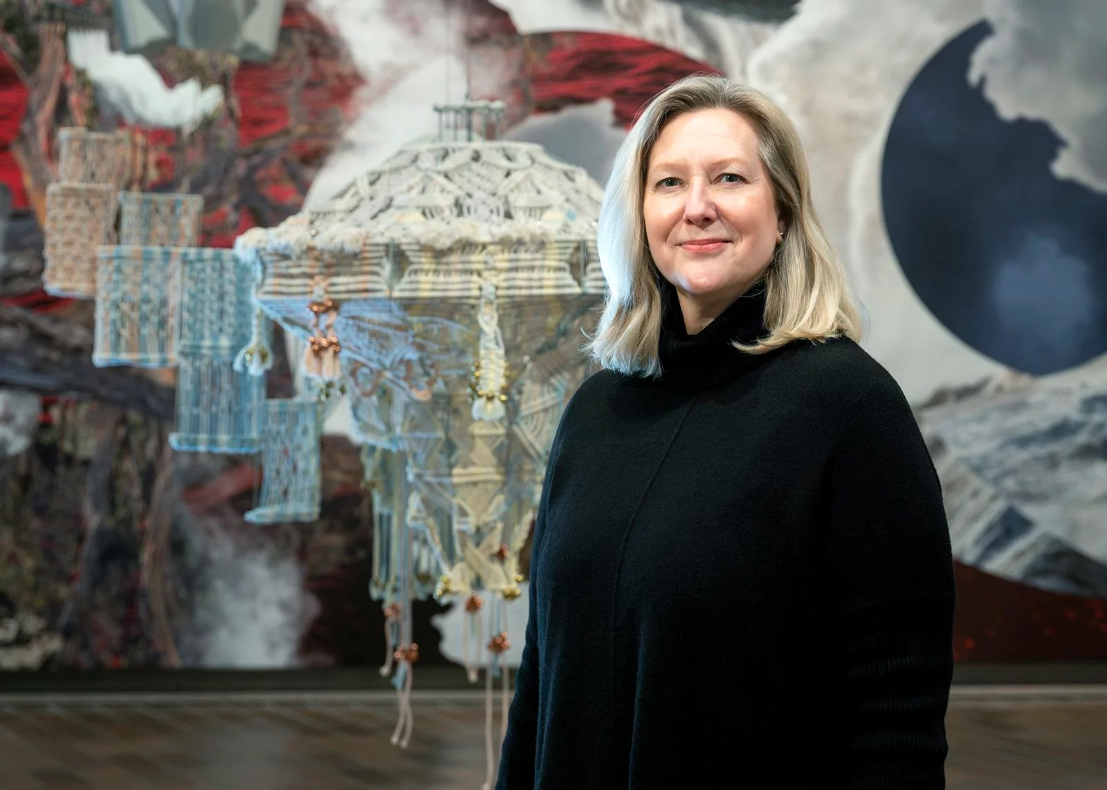 Woman standing in front of a 3D art exhibit.