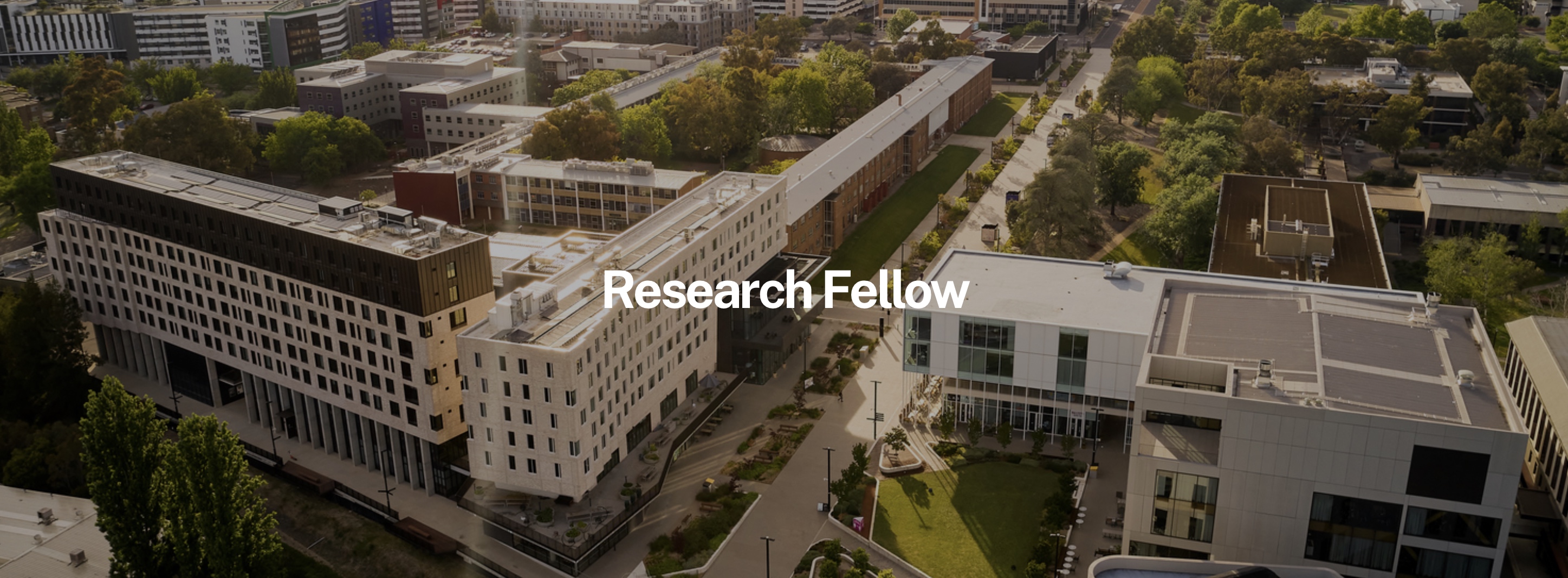 Drone image of a college campus with white text overlaid on the centre for the screen that says, 'Research Fellow'