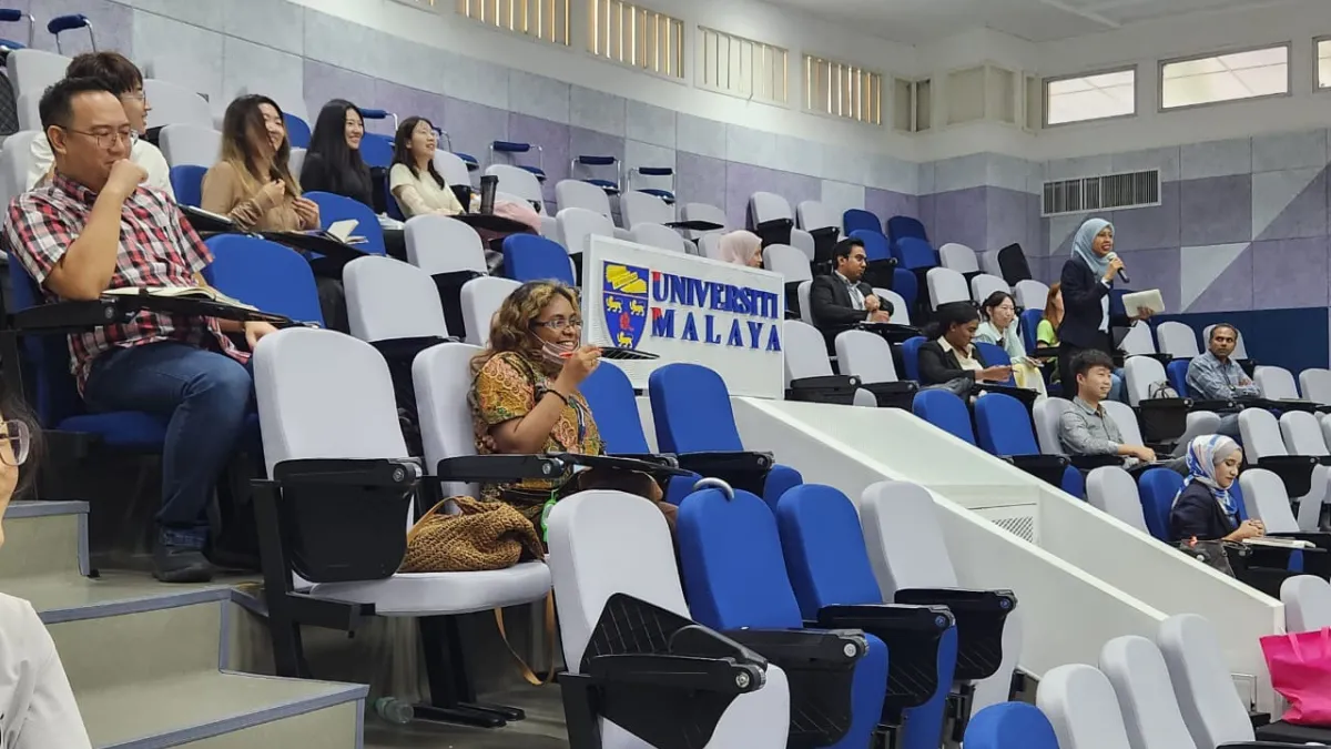A group of people gathered for a lecture sitting in various posts around the room. 