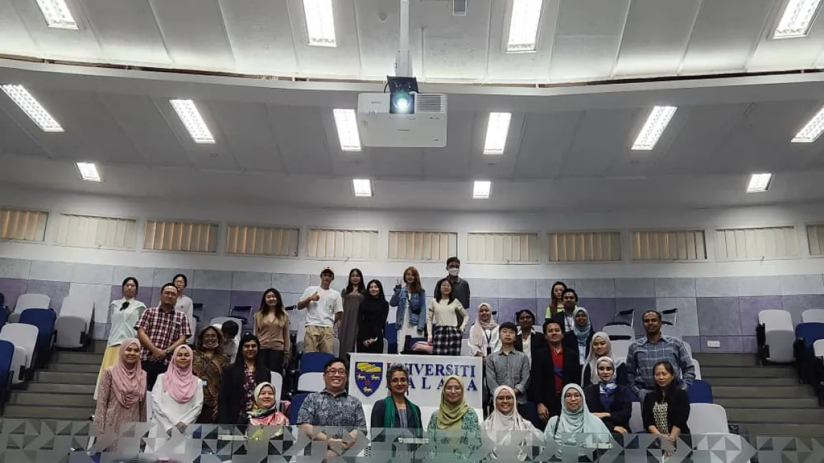 Group of people smiling for a photo after a lecture. 