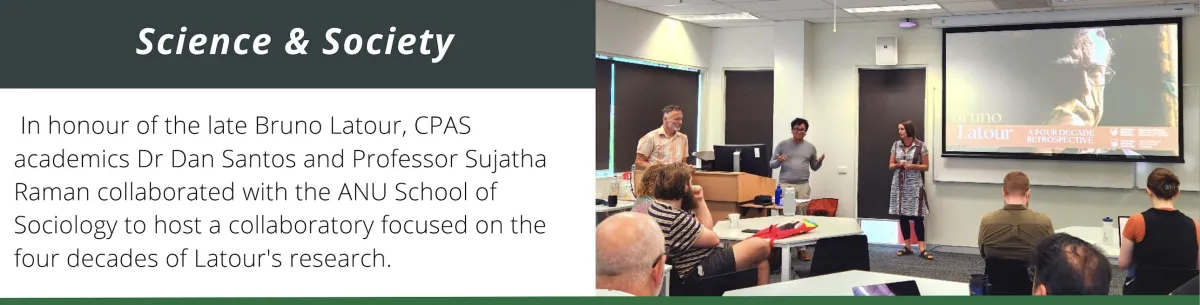 Three people presenting to a room with a projector behind them.