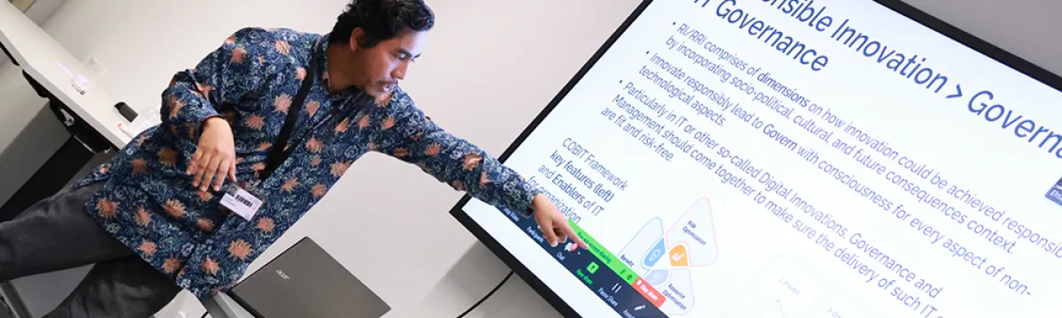 Man standing in front of a powerpoint presentation about Responsible Innovaiton