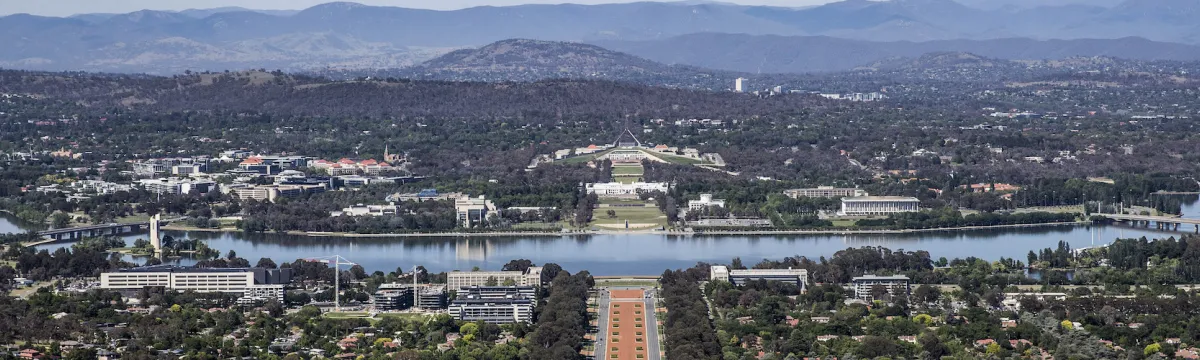 Landscape view of Canberra mountain, lake and city.