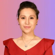 Headshot of an Asian woman with a pink and orange background.
