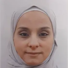 Headshot of a woman with a hijab.