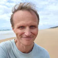 Headshot of man at a beach