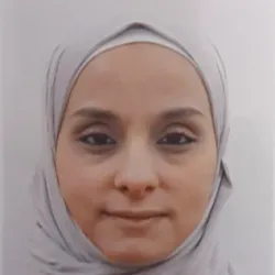 Headshot of a woman with a hijab.