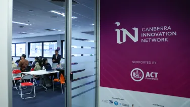 Half a shot looking at a wall and the other half looking into a classroom.